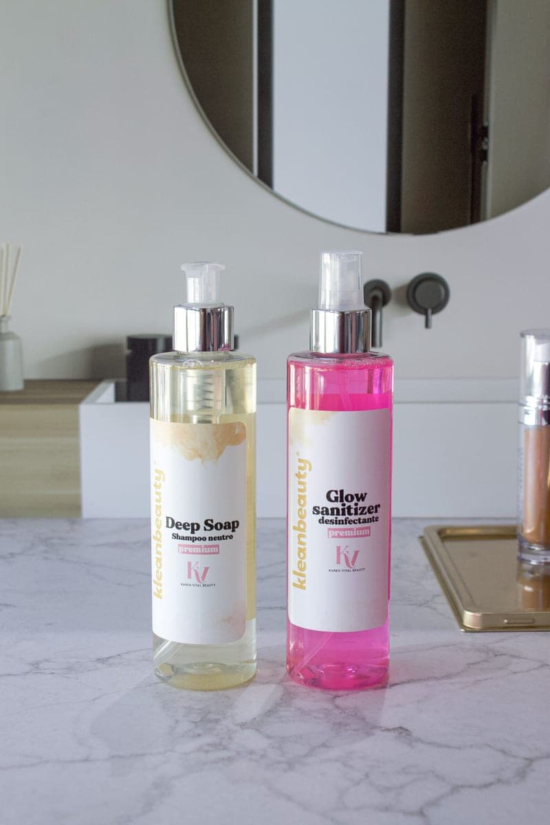 Pump bottles on a marble bathroom counter in bright daylight