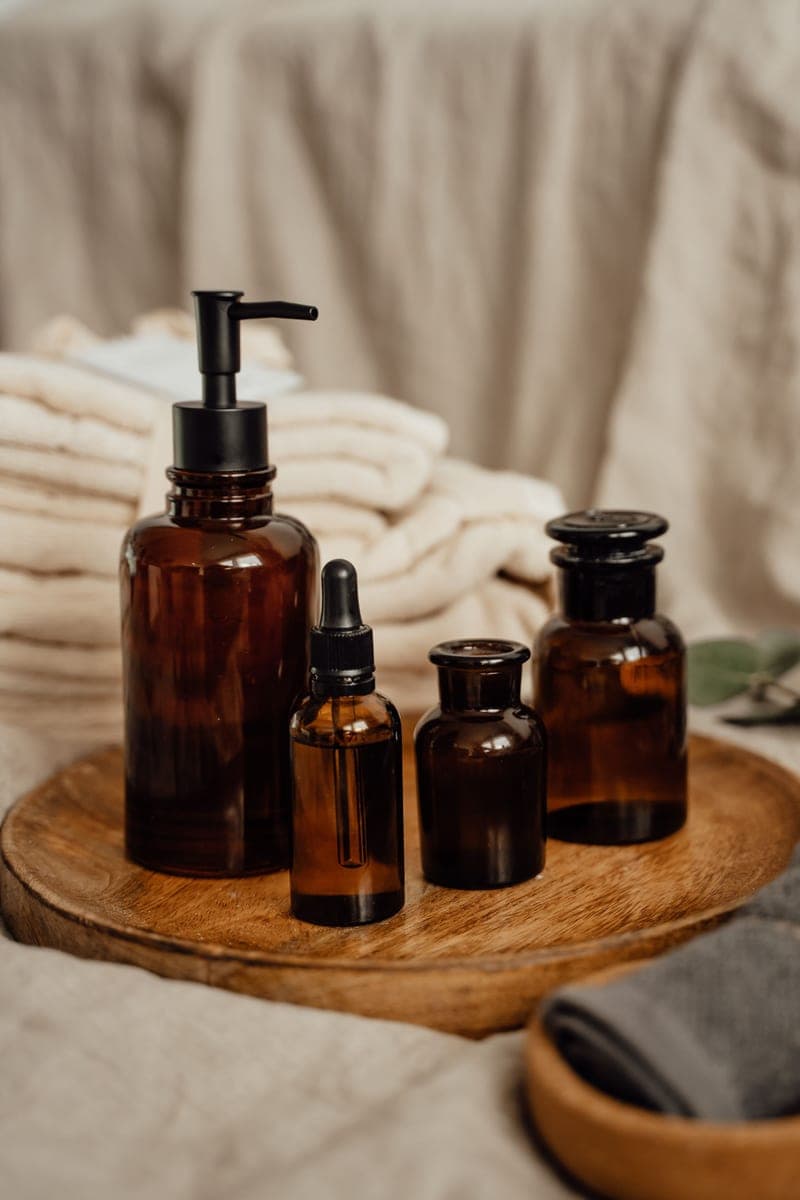 Amber glass bottles arranged on a wooden tray